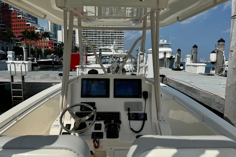 No Name Yacht Photos Pics 2018 Cobia 301 Center Console boat at marina with cityscape background.