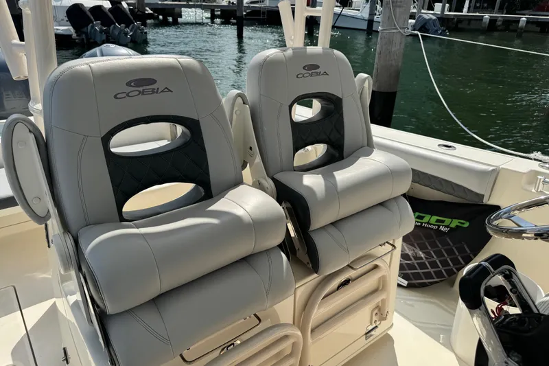 No Name Yacht Photos Pics 2018 Cobia 301 Center Console boat seats, docked by the water.