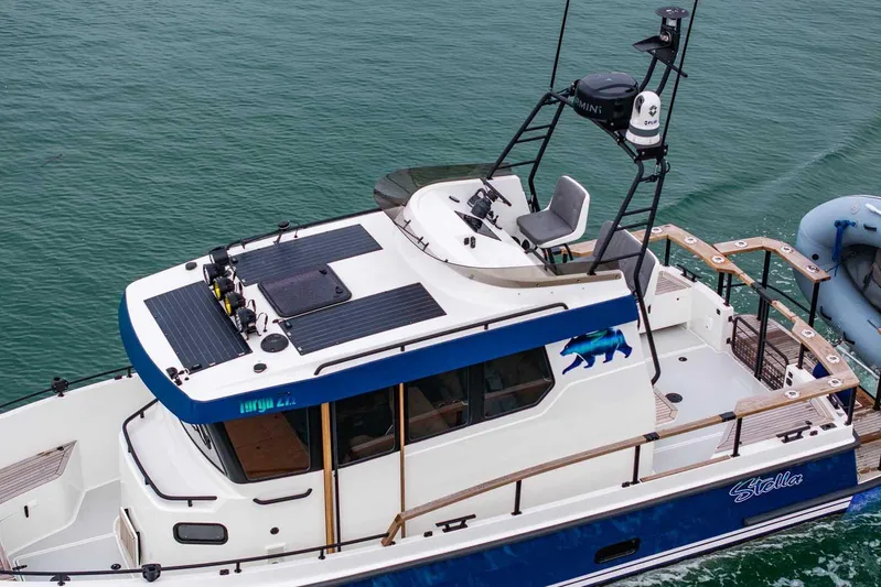  Yacht Photos Pics 2024 Targa 27.2 boat with upper deck seating, cruising on calm waters.