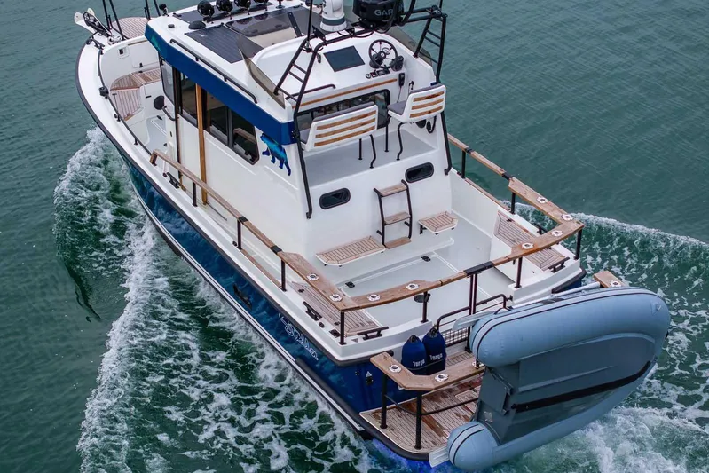  Yacht Photos Pics 2024 Targa 27.2 boat cruising on water, featuring spacious deck and modern design.