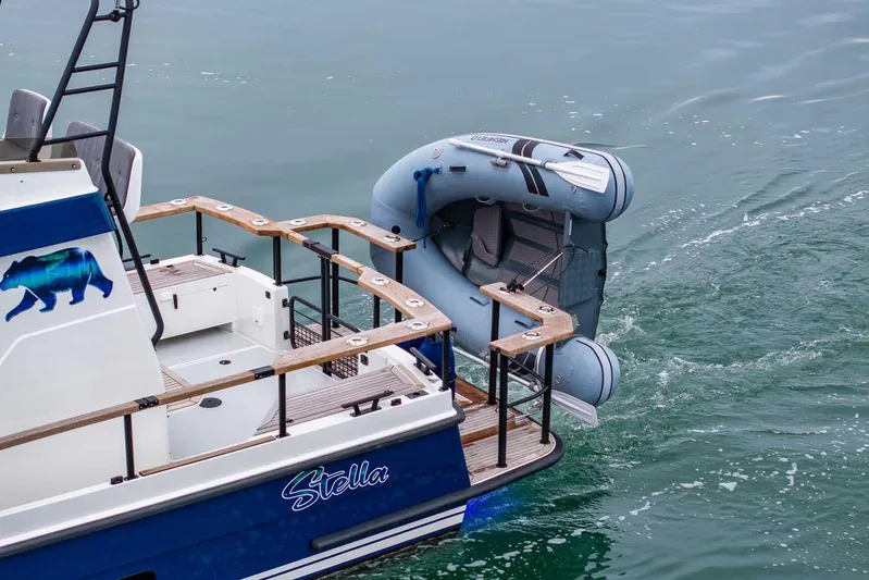  Yacht Photos Pics 2024 Targa 27.2 boat with inflatable dinghy, featuring a bear graphic and "Stella" name.