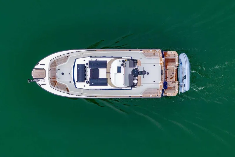  Yacht Photos Pics Aerial view of 2024 Targa 27.2 boat cruising on green water.