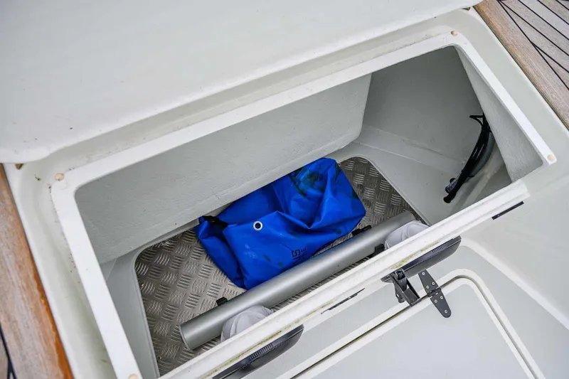  Yacht Photos Pics Open storage compartment on 2024 Targa 27.2 boat with blue bag inside.