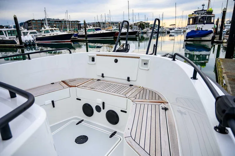 Yacht Photos Pics 2024 Targa 27.2 boat interior with wooden deck, docked in a marina.