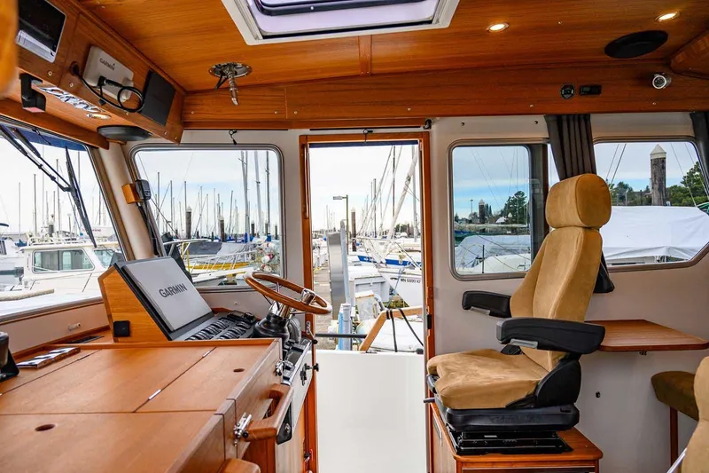  Yacht Photos Pics 2024 Targa 27.2 boat interior with navigation equipment and comfortable seating.
