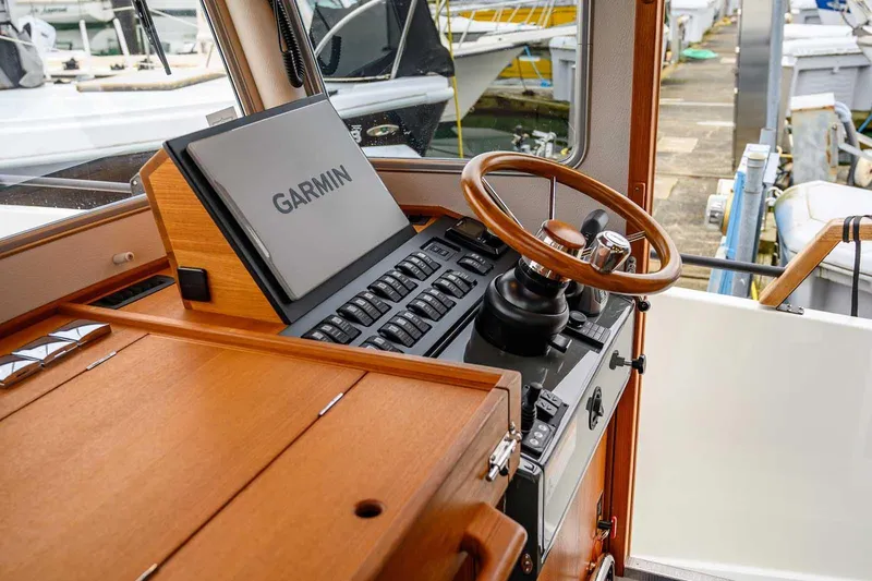  Yacht Photos Pics 2024 Targa 27.2 boat helm with Garmin navigation and wooden steering wheel.