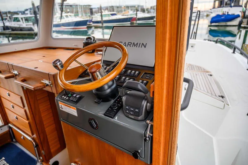  Yacht Photos Pics 2024 Targa 27.2 boat helm with wooden steering wheel and Garmin navigation system.
