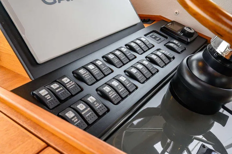  Yacht Photos Pics Control panel of 2024 Targa 27.2 boat with multiple switches and steering wheel.