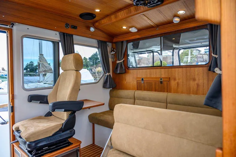  Yacht Photos Pics 2024 Targa 27.2 boat interior with plush seating and wooden accents.