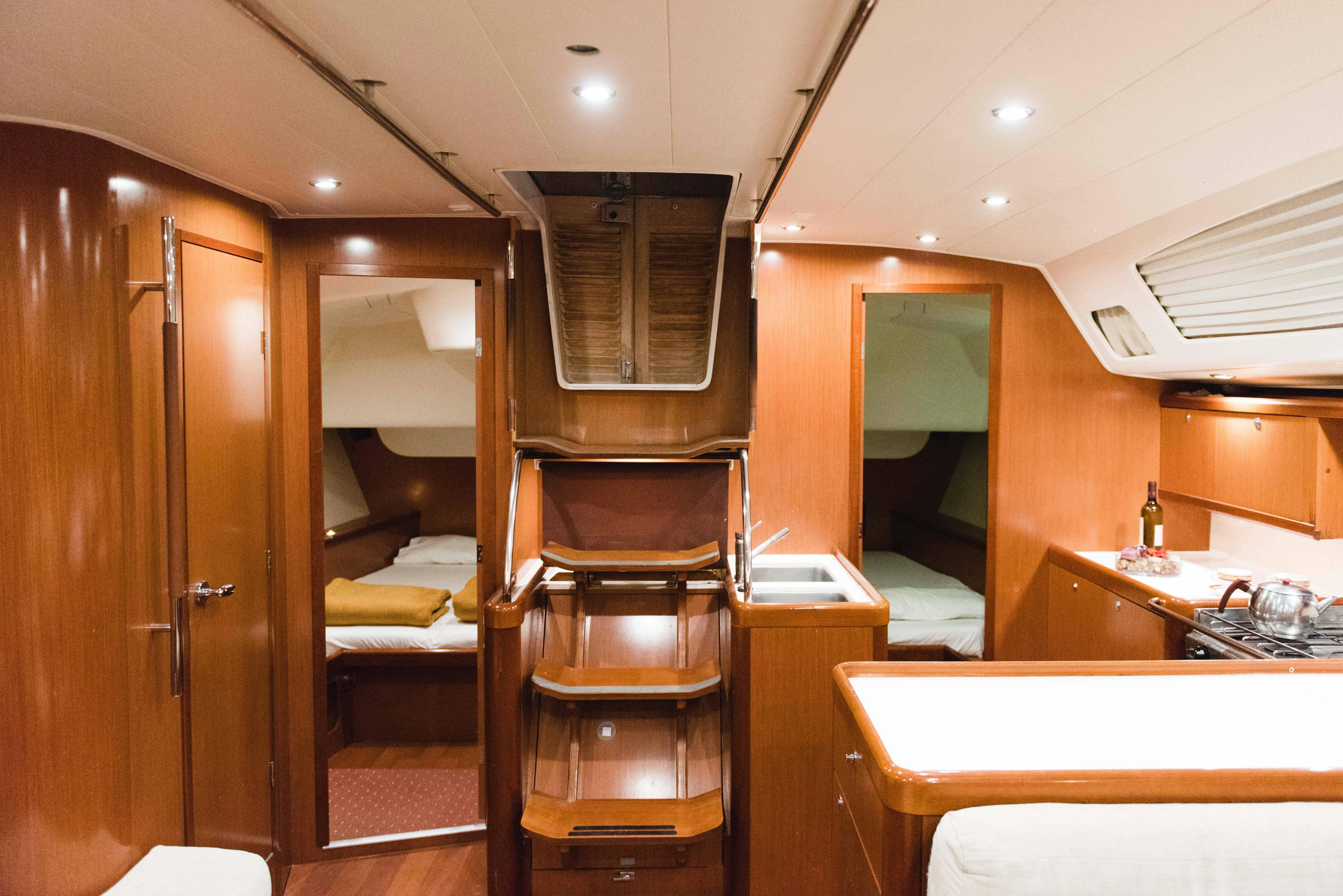  Yacht Photos Pics Luxurious interior of 2009 Beneteau Oceanis 54 yacht with wood finish and modern amenities.