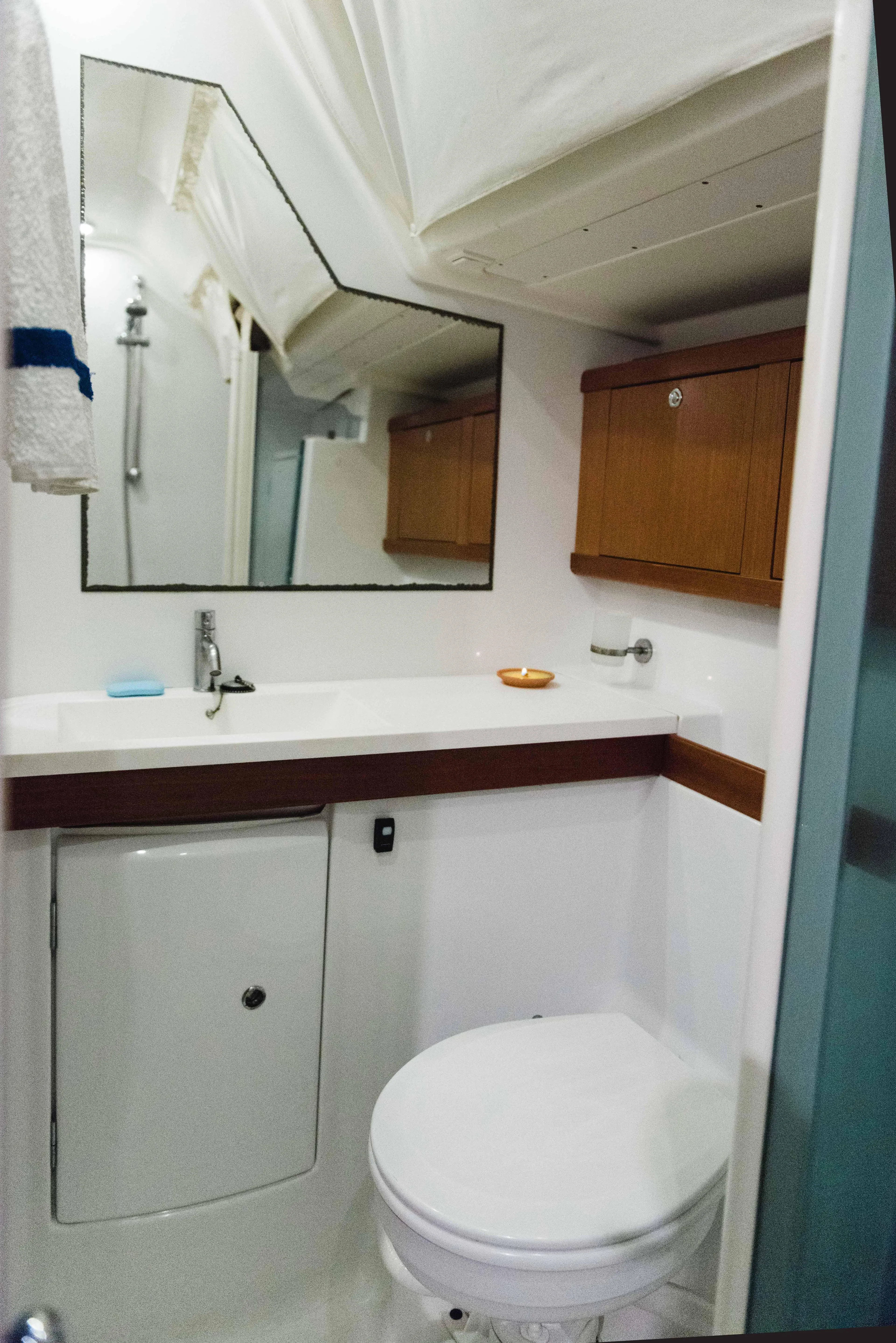  Yacht Photos Pics Bathroom interior of a 2009 Beneteau Oceanis 54 yacht, featuring modern fixtures and wooden cabinetry.