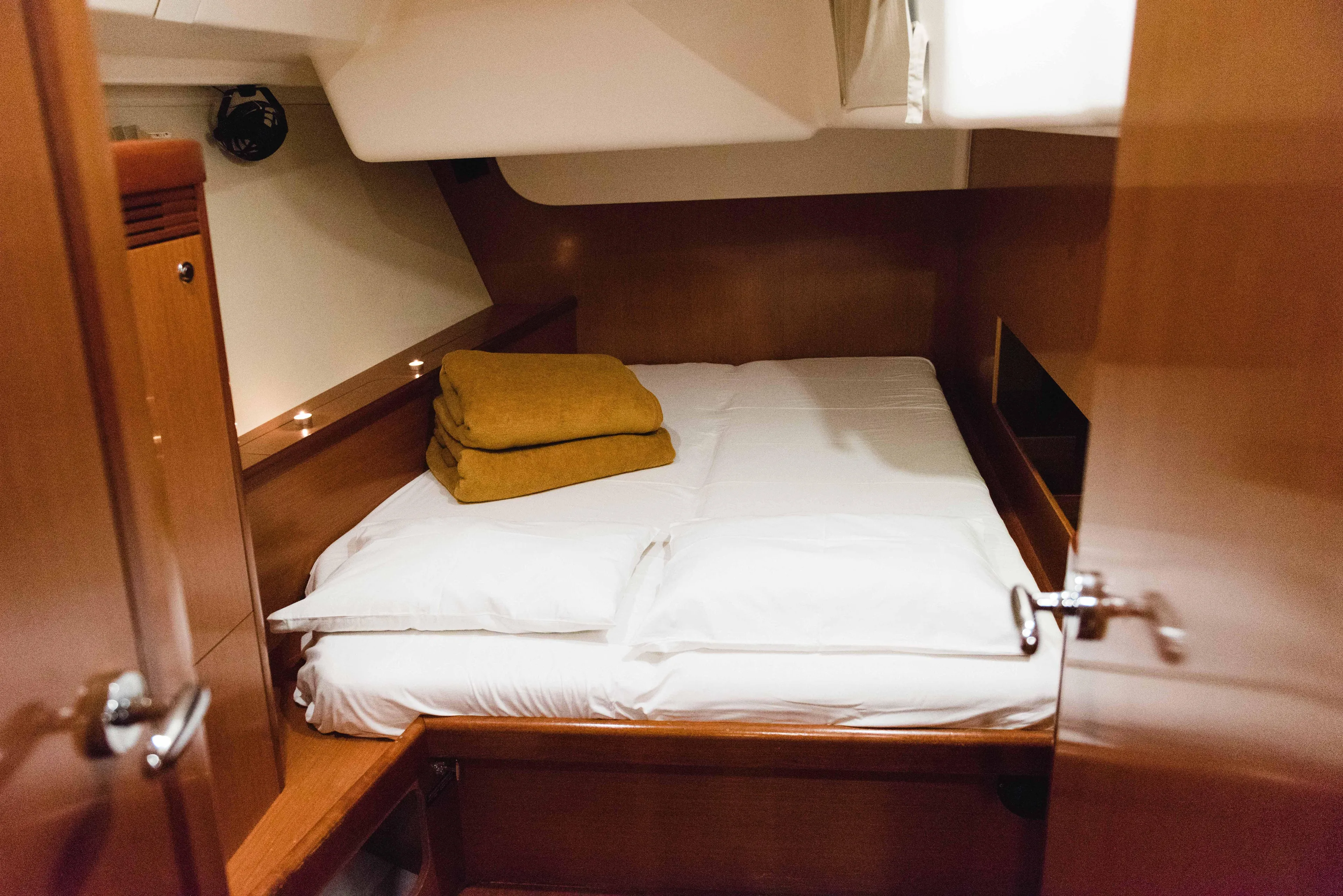  Yacht Photos Pics Cozy cabin interior of 2009 Beneteau Oceanis 54 yacht with neatly arranged bedding.