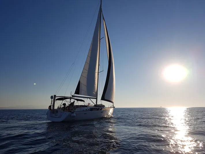  Yacht Photos Pics Sailing yacht Beneteau Oceanis 54 (2009) on calm sea at sunset.