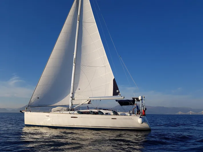  Yacht Photos Pics Sailing yacht Beneteau Oceanis 54, 2009 model, gliding on calm blue waters under clear skies.
