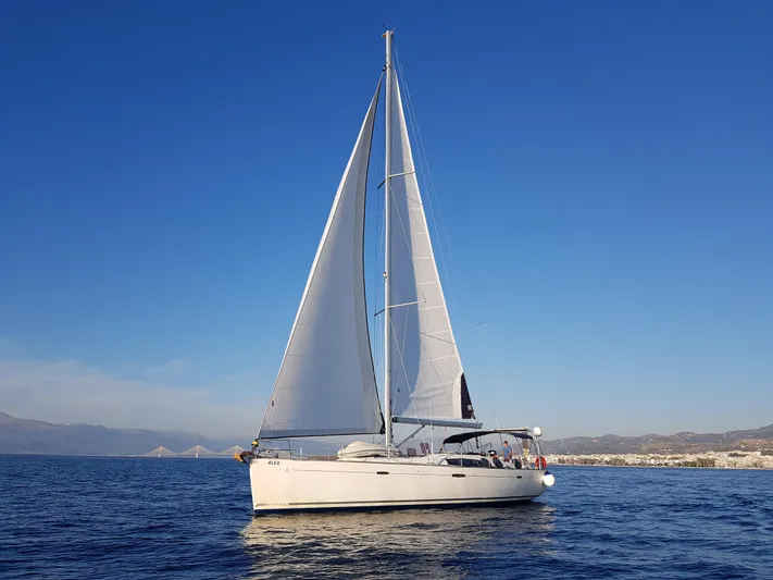  Yacht Photos Pics 2009 Beneteau Oceanis 54 sailing on calm blue waters under clear skies.