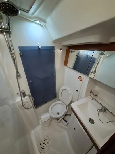  Yacht Photos Pics Bathroom interior of 2009 Beneteau Oceanis 54 yacht, featuring shower, toilet, and sink.