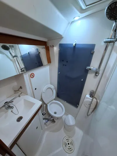  Yacht Photos Pics Bathroom interior of 2009 Beneteau Oceanis 54 yacht, featuring shower, toilet, and sink.