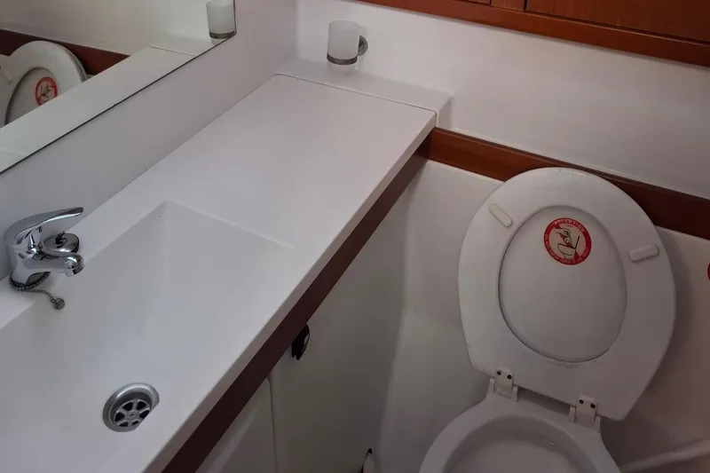 Yacht Photos Pics 2009 Beneteau Oceanis 54 bathroom with sink and toilet, featuring modern fixtures.