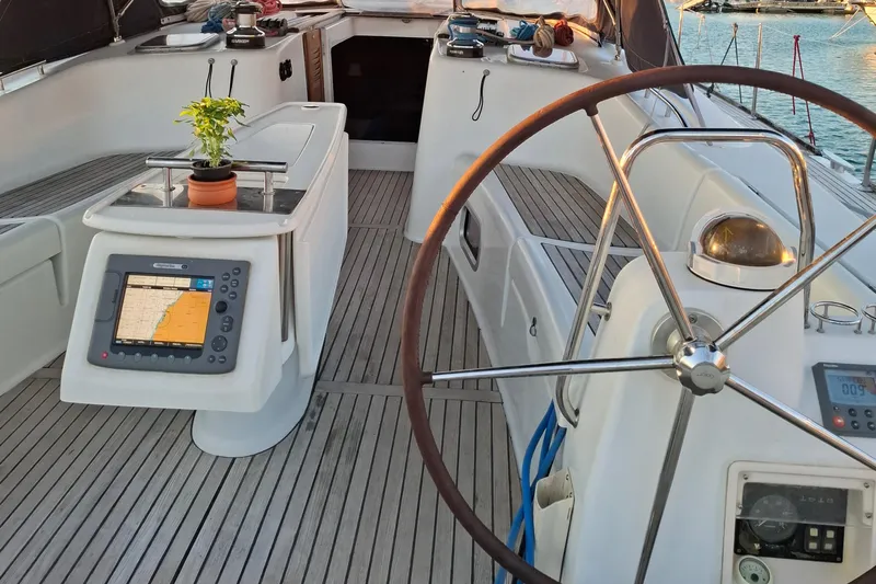  Yacht Photos Pics 2009 Beneteau Oceanis 54 yacht cockpit with navigation equipment and potted plant.