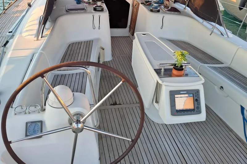  Yacht Photos Pics 2009 Beneteau Oceanis 54 yacht cockpit with steering wheel, navigation system, and seating.