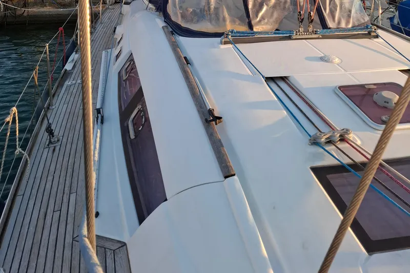  Yacht Photos Pics 2009 Beneteau Oceanis 54 sailboat deck with ropes and windows, docked at marina.