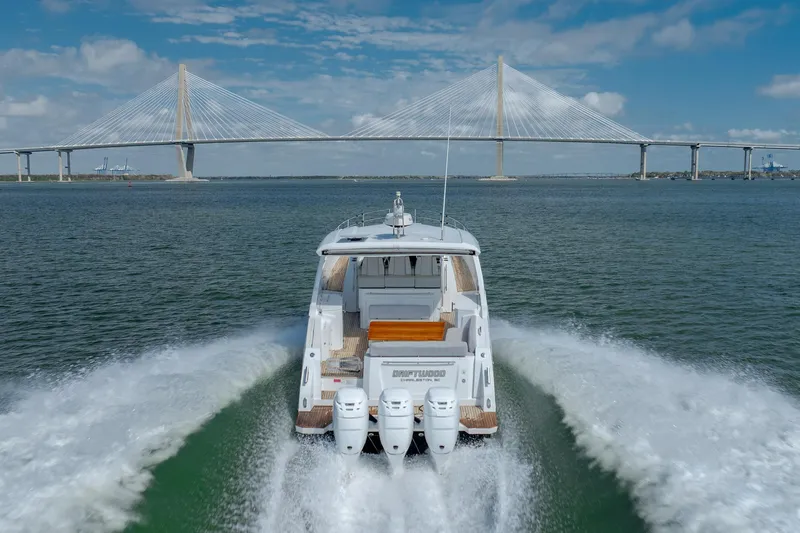  Yacht Photos Pics 2019 Azimut Verve 40 yacht cruising under a suspension bridge on a sunny day.