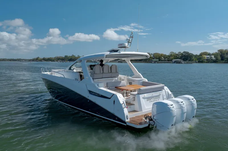  Yacht Photos Pics 2019 Azimut Verve 40 yacht cruising on a calm lake under a clear blue sky.