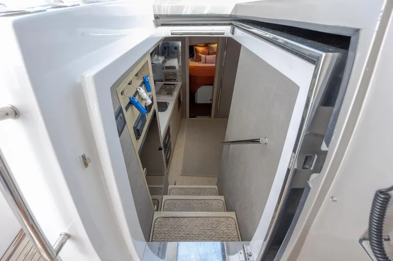  Yacht Photos Pics Interior view of 2019 Azimut Verve 40 yacht, featuring stairs and compact kitchen area.