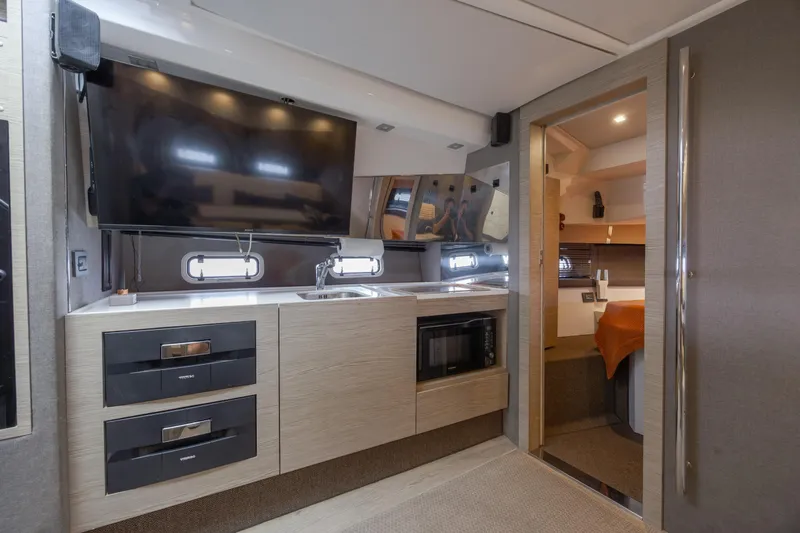  Yacht Photos Pics Luxurious interior of 2019 Azimut Verve 40 yacht with modern kitchen and TV.