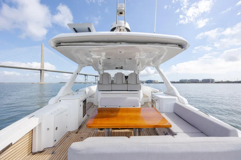  Yacht Photos Pics 2019 Azimut Verve 40 yacht with spacious deck, wooden table, and scenic bridge view.