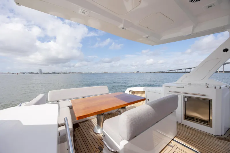  Yacht Photos Pics 2019 Azimut Verve 40 yacht deck with seating, table, and ocean view.