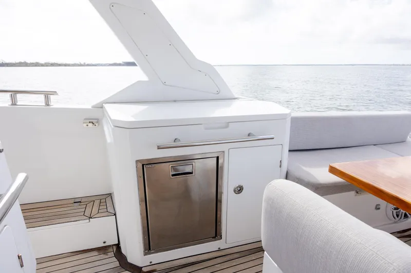  Yacht Photos Pics 2019 Azimut Verve 40 yacht deck with seating and storage, overlooking serene waters.