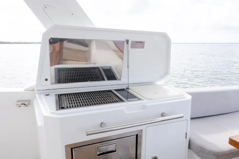  Yacht Photos Pics Outdoor grill on 2019 Azimut Verve 40 yacht, overlooking serene water.