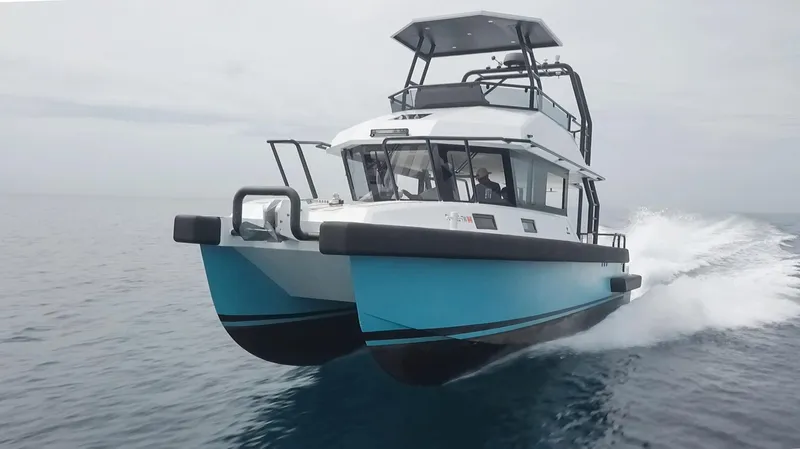  Yacht Photos Pics 2023 Custom Vandal Explorer 46 catamaran cruising on open water.