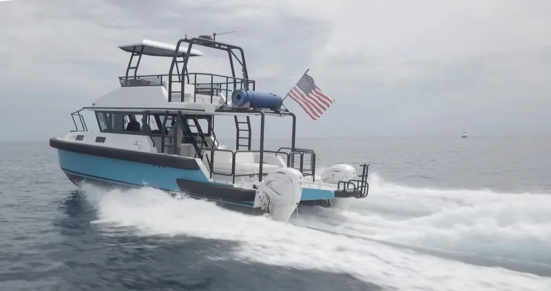  Yacht Photos Pics 2023 Custom Vandal Explorer 46 boat cruising on open water with American flag.