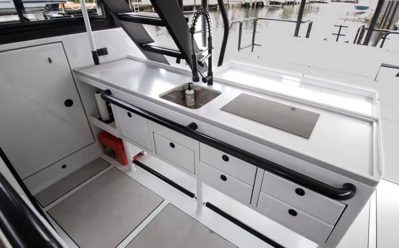  Yacht Photos Pics Modern kitchen area on 2023 Custom Vandal Explorer 46 yacht, featuring sleek countertops and storage.