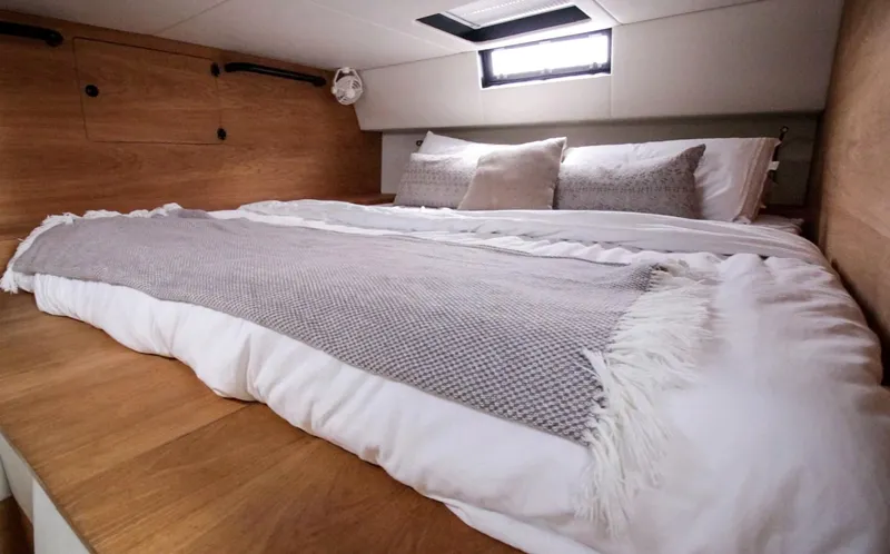  Yacht Photos Pics Luxurious bedroom interior of 2023 Custom Vandal Explorer 46 yacht with cozy bedding.