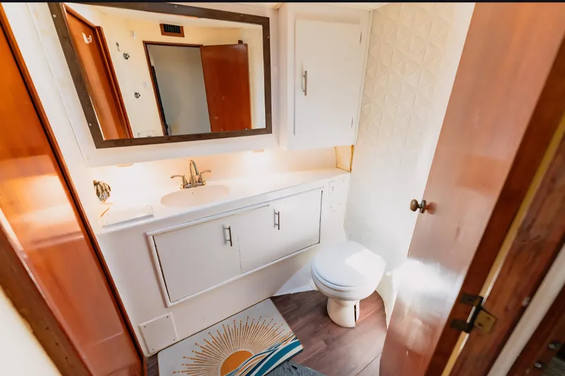  Yacht Photos Pics Bathroom interior of 1988 Ocean Yachts 48 Super Sport with sink, mirror, and toilet.