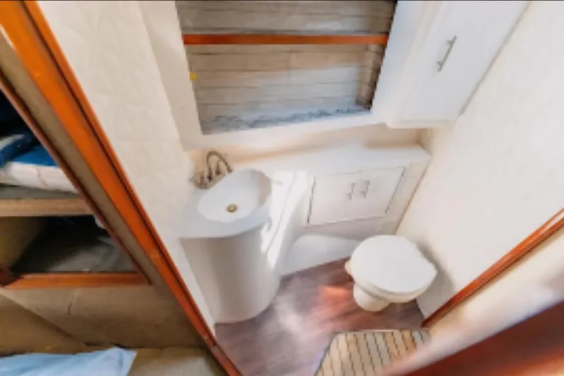  Yacht Photos Pics Bathroom interior of 1988 Ocean Yachts 48 Super Sport, featuring sink and toilet.