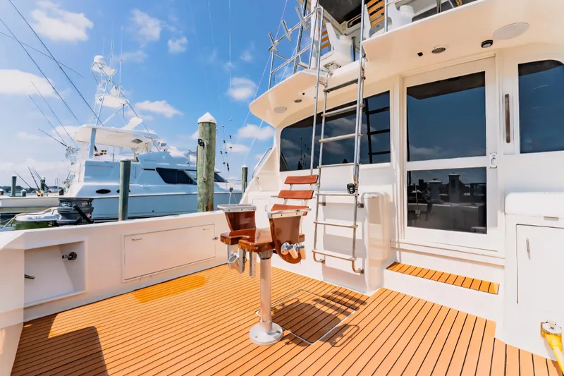  Yacht Photos Pics 1988 Ocean Yachts 48 Super Sport fishing deck with chair and ladder under blue sky.