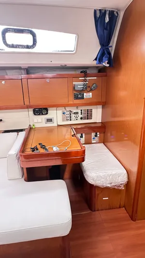  Yacht Photos Pics Interior of 2010 Beneteau Oceanis 50 yacht with wooden cabinetry and seating area.