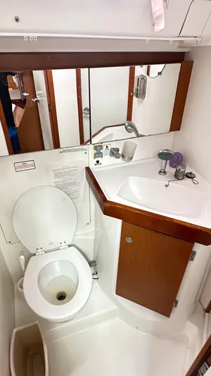  Yacht Photos Pics Bathroom in 2010 Beneteau Oceanis 50 yacht, featuring toilet and sink.