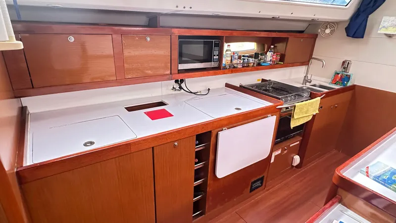  Yacht Photos Pics Modern galley kitchen in 2010 Beneteau Oceanis 50 yacht with wood cabinetry and appliances.