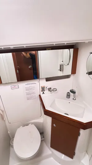  Yacht Photos Pics Bathroom interior of 2010 Beneteau Oceanis 50 yacht with sink and toilet.
