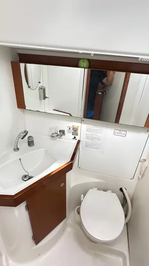  Yacht Photos Pics Beneteau Oceanis 50 bathroom interior, featuring sink, mirror, and toilet, 2010 model.