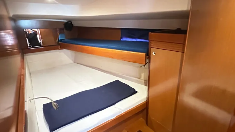  Yacht Photos Pics Cozy cabin interior of 2010 Beneteau Oceanis 50 sailboat with wooden furnishings.