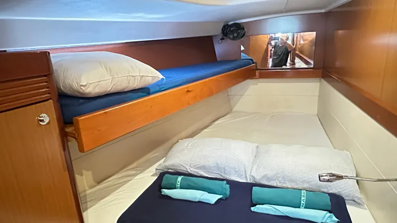  Yacht Photos Pics Cozy cabin interior of 2010 Beneteau Oceanis 50 sailboat with bunk beds and pillows.