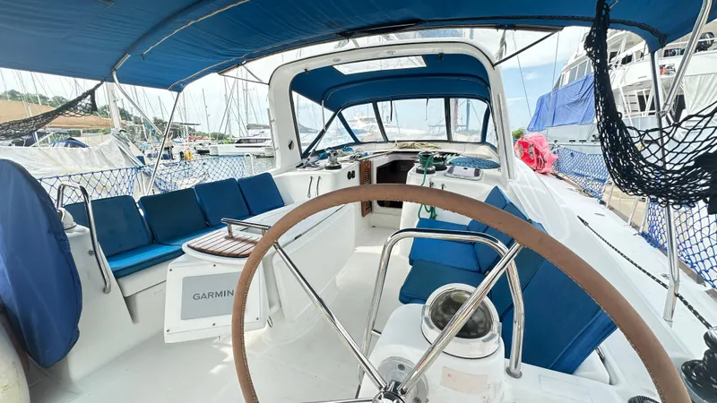  Yacht Photos Pics Cockpit of 2010 Beneteau Oceanis 50 sailboat with blue seating and steering wheel.