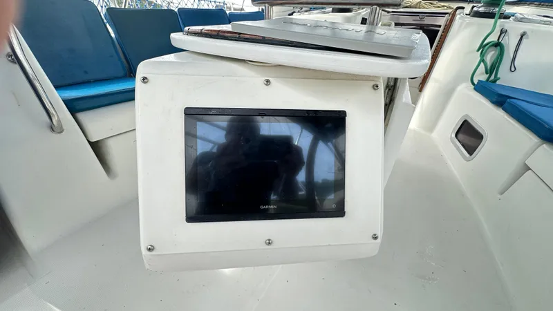  Yacht Photos Pics Beneteau Oceanis 50 cockpit with Garmin display, blue seating, and nautical equipment, 2010 model.