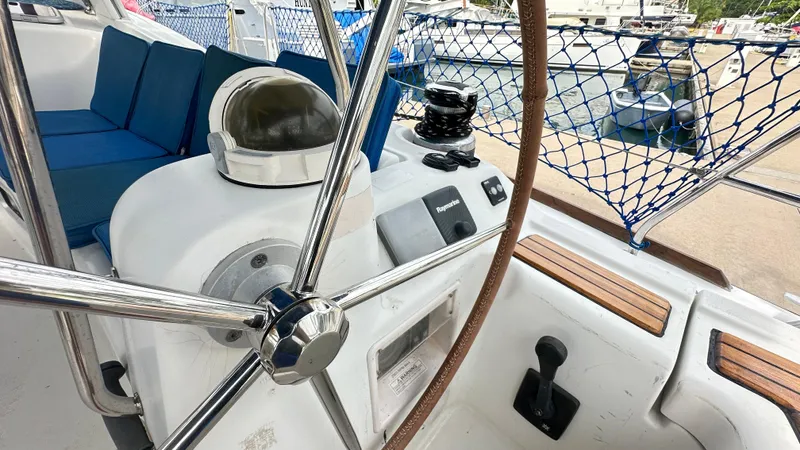  Yacht Photos Pics Cockpit of 2010 Beneteau Oceanis 50 sailboat with steering wheel and navigation equipment.